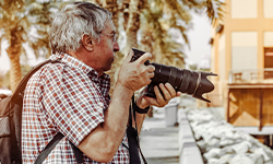 elderly man with camera