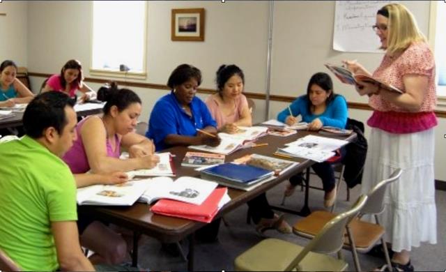 a woman teaching a class to other adults