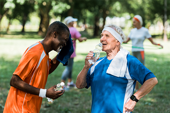 elderly men drinking water after exercising