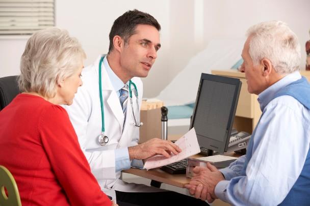 doctor talking with elderly couple