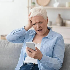 an alarmed woman looking at her phone