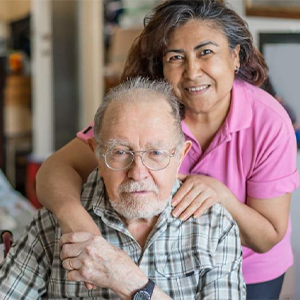 An elderly man with his caregiver