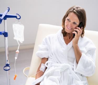 patient connected to an I.V. while talking on a cell phone