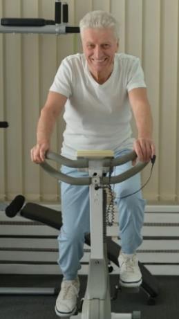 older man riding on a stationary bike