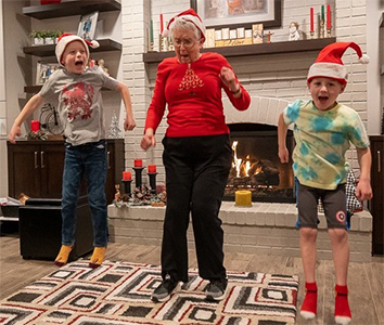 marti playing with her grandkids on christmas