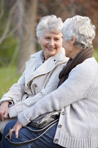 two older women sitting on a bench