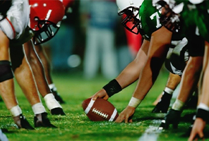 two football teams lined up about to start a play