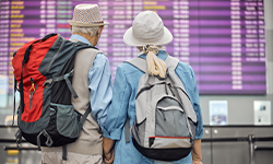 two elderly people at an airport