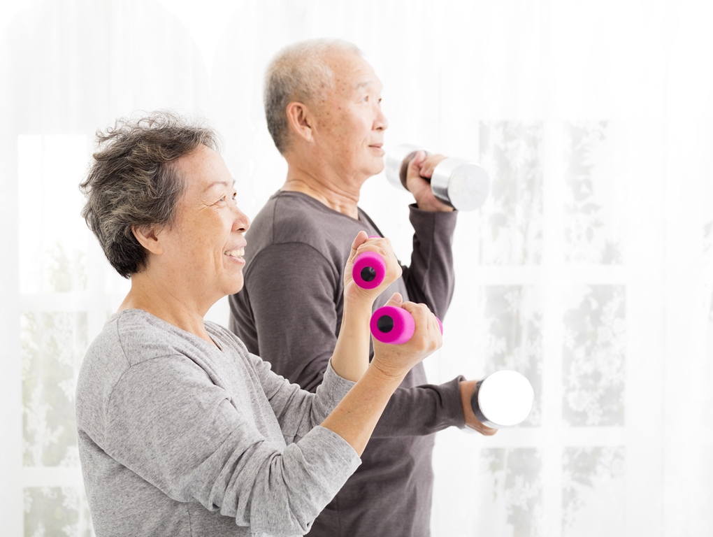 elderly people lifting weights