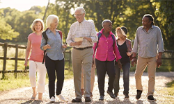 group of aging adults walking on a trail