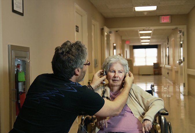 man helping old woman